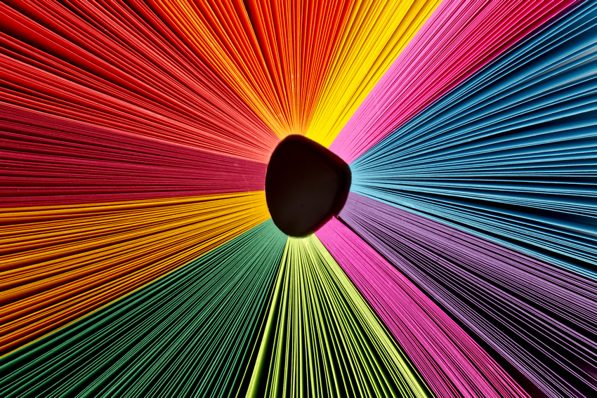 detailed image of colour strings A radial arrangement of multi-colored paper sheets fanned out in a circle, symbolizing the vibrant diversity of an open source ecosystem.